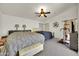 Large bedroom with gray carpet, ceiling fan, and two beds for comfortable living at 1322 S 118Th Dr, Avondale, AZ 85323