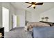 Bright main bedroom with gray carpet, fan, offering spacious comfort and natural light at 1322 S 118Th Dr, Avondale, AZ 85323