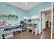 A spacious, light-blue room with stainless steel tables, rolling chair and ample storage at 1322 S 118Th Dr, Avondale, AZ 85323