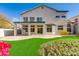 A two-story home showing the manicured backyard and second story patio at 1331 E Voltaire Ave, Phoenix, AZ 85022