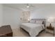 Bright bedroom features ceiling fan, carpet, and large window with decorative shutters at 1331 E Voltaire Ave, Phoenix, AZ 85022