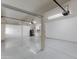 A bright garage with built in cabinets, water heater, and coated flooring at 1331 E Voltaire Ave, Phoenix, AZ 85022