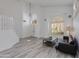 Bright, open living room with wood flooring, modern lighting, and stylish shutters at 1331 E Voltaire Ave, Phoenix, AZ 85022