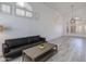 Bright, open living room with wood flooring, modern lighting, and stylish shutters at 1331 E Voltaire Ave, Phoenix, AZ 85022