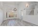Bright, open living room with wood flooring, modern lighting, and stylish shutters at 1331 E Voltaire Ave, Phoenix, AZ 85022