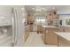 Well-lit kitchen with island, white cabinets, and modern stainless steel appliances at 13514 W Wagon Wheel Dr, Sun City West, AZ 85375