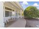 Covered patio with outdoor seating, white table and chairs and lush citrus tree at 13514 W Wagon Wheel Dr, Sun City West, AZ 85375