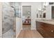 An elegant bathroom features a glass-enclosed shower and double vanity with modern fixtures at 14010 N 12Th St, Phoenix, AZ 85022