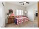 Bedroom featuring carpeted floors, ceiling fan, and ensuite bathroom at 14010 N 12Th St, Phoenix, AZ 85022