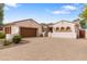 Attractive single-story home with stucco exterior, tile roof, and a brick driveway at 14010 N 12Th St, Phoenix, AZ 85022