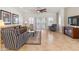 Bright living room featuring tile floors, comfortable seating, and sliding glass doors to the backyard at 14010 N 12Th St, Phoenix, AZ 85022