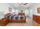 Bright bedroom featuring wood floors, shutters, and a ceiling fan at 14010 N 12Th St, Phoenix, AZ 85022