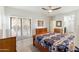 Bright bedroom featuring wood floors, shutters, and a ensuite bathroom at 14010 N 12Th St, Phoenix, AZ 85022