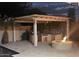 Outdoor kitchen with a fire pit and a built-in grill, set against the backdrop of a peaceful evening sky at 14010 N 12Th St, Phoenix, AZ 85022