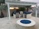 Outdoor kitchen under a pergola, equipped with a grill, smoker, and a fire pit at 14010 N 12Th St, Phoenix, AZ 85022