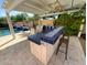 Covered outdoor kitchen by the pool, featuring a built-in grill, counter space, and seating at 14010 N 12Th St, Phoenix, AZ 85022