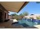 A luxurious pool boasts water features and a covered patio, perfect for relaxation and entertaining at 14010 N 12Th St, Phoenix, AZ 85022