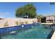 Sparkling pool with tiled water features enhances the beautifully landscaped backyard oasis at 14010 N 12Th St, Phoenix, AZ 85022
