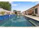 Stunning pool with a covered patio, outdoor kitchen, and lush landscaping perfect for entertaining at 14010 N 12Th St, Phoenix, AZ 85022