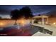 Backyard at dusk featuring a pool, an outdoor kitchen, and ambient lighting at 14010 N 12Th St, Phoenix, AZ 85022