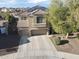 View of a home with desert landscaping, solar panels, and a three-car garage at 14258 W Lisbon Ln, Surprise, AZ 85379