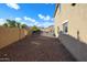 Spacious backyard featuring a rock landscape, block fence, and relaxing outdoor space at 14258 W Lisbon Ln, Surprise, AZ 85379