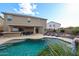 Backyard oasis featuring a private pool, patio area, built-in grill, and lounge seating at 14258 W Lisbon Ln, Surprise, AZ 85379