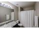 Well-lit bathroom with a granite countertop vanity, shower, and tile flooring at 14258 W Lisbon Ln, Surprise, AZ 85379