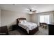Comfortable bedroom with a ceiling fan, natural light, and neutral decor at 14258 W Lisbon Ln, Surprise, AZ 85379