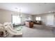 Spacious living room with carpeted floors, neutral walls, and ample natural light from large windows at 14258 W Lisbon Ln, Surprise, AZ 85379
