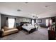 Large main bedroom featuring comfortable seating, ceiling fan, and ample natural light at 14258 W Lisbon Ln, Surprise, AZ 85379