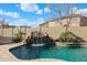 Beautiful backyard pool with rock waterfall feature, perfect for relaxing and entertaining at 14258 W Lisbon Ln, Surprise, AZ 85379
