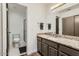 Clean bathroom with granite countertop vanity, updated fixtures, and tiled shower at 14300 W Bell Rd # 307, Surprise, AZ 85374