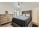 Cozy bedroom featuring a large bed with upholstered headboard and a sliding glass door at 14300 W Bell Rd # 307, Surprise, AZ 85374
