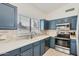 Updated kitchen with sleek, stainless steel appliances and bright, modern backsplash at 14300 W Bell Rd # 307, Surprise, AZ 85374