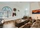 Inviting living room with wood floors, high ceilings, large windows, and comfortable seating at 14300 W Bell Rd # 307, Surprise, AZ 85374