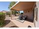 Covered back patio with outdoor furniture and landscaping at 15561 W Vista Grande Ln, Surprise, AZ 85374