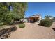 Spacious backyard with desert landscaping and a covered patio at 15561 W Vista Grande Ln, Surprise, AZ 85374