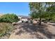 Lush backyard featuring desert landscaping and a covered patio at 15561 W Vista Grande Ln, Surprise, AZ 85374