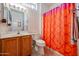 Bathroom boasting a wood vanity cabinet and a colorful patterned shower curtain at 15561 W Vista Grande Ln, Surprise, AZ 85374