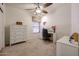 Bright bedroom with a dresser, desk, chair, and a ceiling fan creating a comfortable and functional space at 15561 W Vista Grande Ln, Surprise, AZ 85374