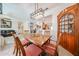 Charming dining room featuring a classic wooden table, cabinet and stylish light fixture, perfect for Gathering gatherings at 15561 W Vista Grande Ln, Surprise, AZ 85374