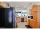 Bright kitchen with stainless steel appliances, wood cabinetry, and open layout at 15561 W Vista Grande Ln, Surprise, AZ 85374