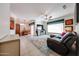 Spacious living room with a comfortable leather sectional sofa, ceiling fan, and a view of the dining area at 15561 W Vista Grande Ln, Surprise, AZ 85374