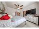 Comfortable main bedroom featuring a ceiling fan, and a large TV, offering a relaxing and private space at 15561 W Vista Grande Ln, Surprise, AZ 85374