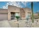 Inviting single-story home with desert landscaping, rock accents, and an attached garage at 17234 E Sunscape Dr, Fountain Hills, AZ 85268