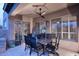 Covered patio with tile flooring, dining set, ceiling fan and shade shutters for outdoor relaxation at 17234 E Sunscape Dr, Fountain Hills, AZ 85268