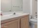 Bathroom featuring a traditional-style vanity and sink, with shower and toilet visible in the background at 18218 N 136Th Ave, Sun City West, AZ 85375