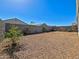 Large backyard featuring gravel ground cover and privacy wall, offering a blank canvas for landscaping ideas at 18809 W Wilson St, Buckeye, AZ 85326