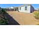 Wide angle view of a large backyard featuring gravel ground cover and privacy wall at 18809 W Wilson St, Buckeye, AZ 85326